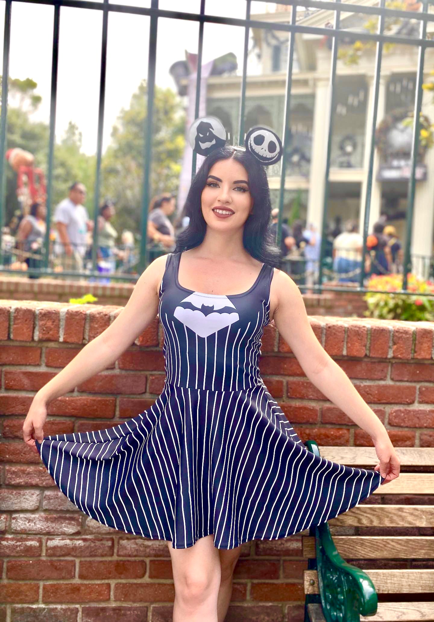 Our model stands outside of the haunted mansion holiday attraction showing off her jack skellington dress while at Disneyland.
